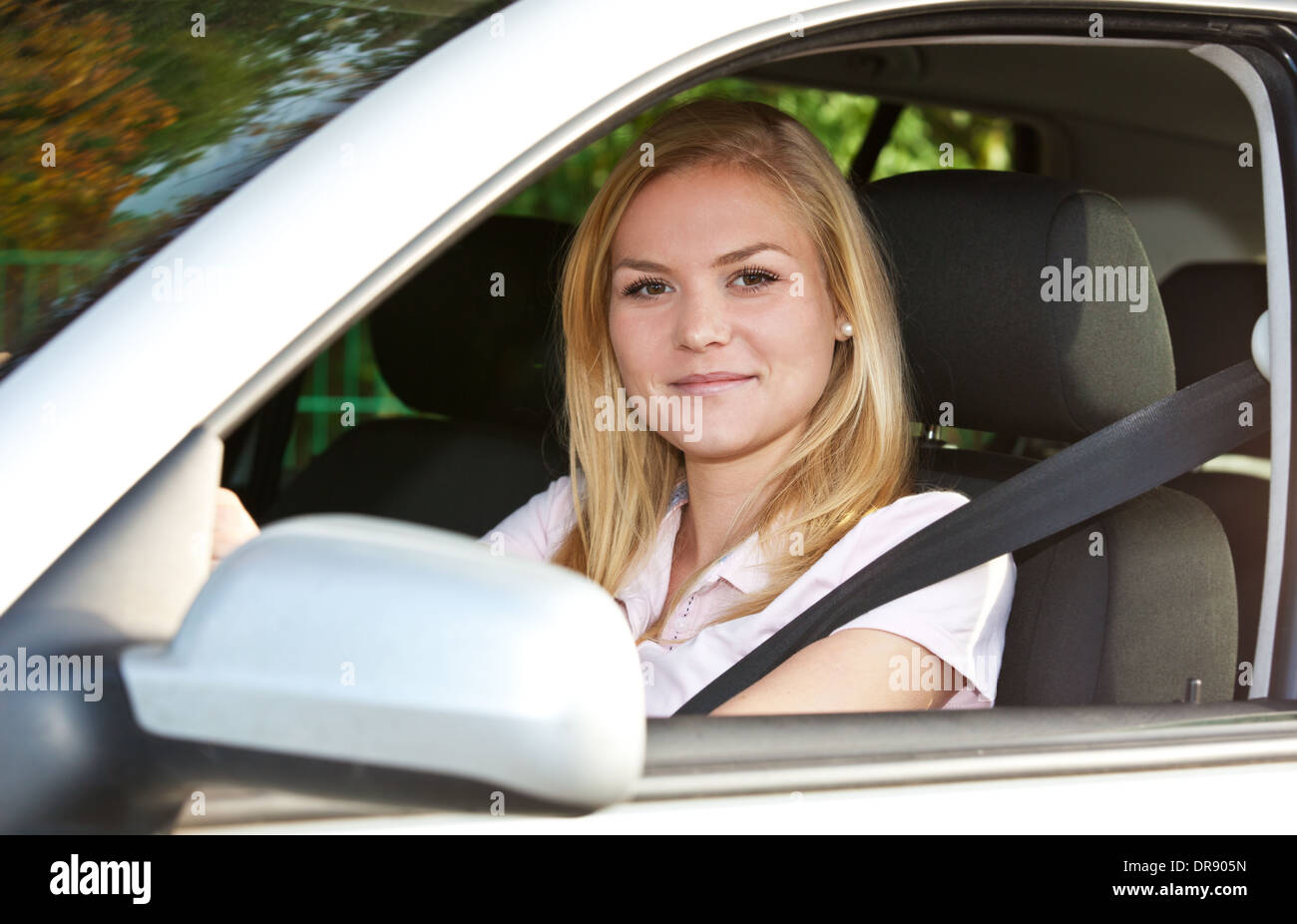 Attractive young woman in her car. Stock Photo