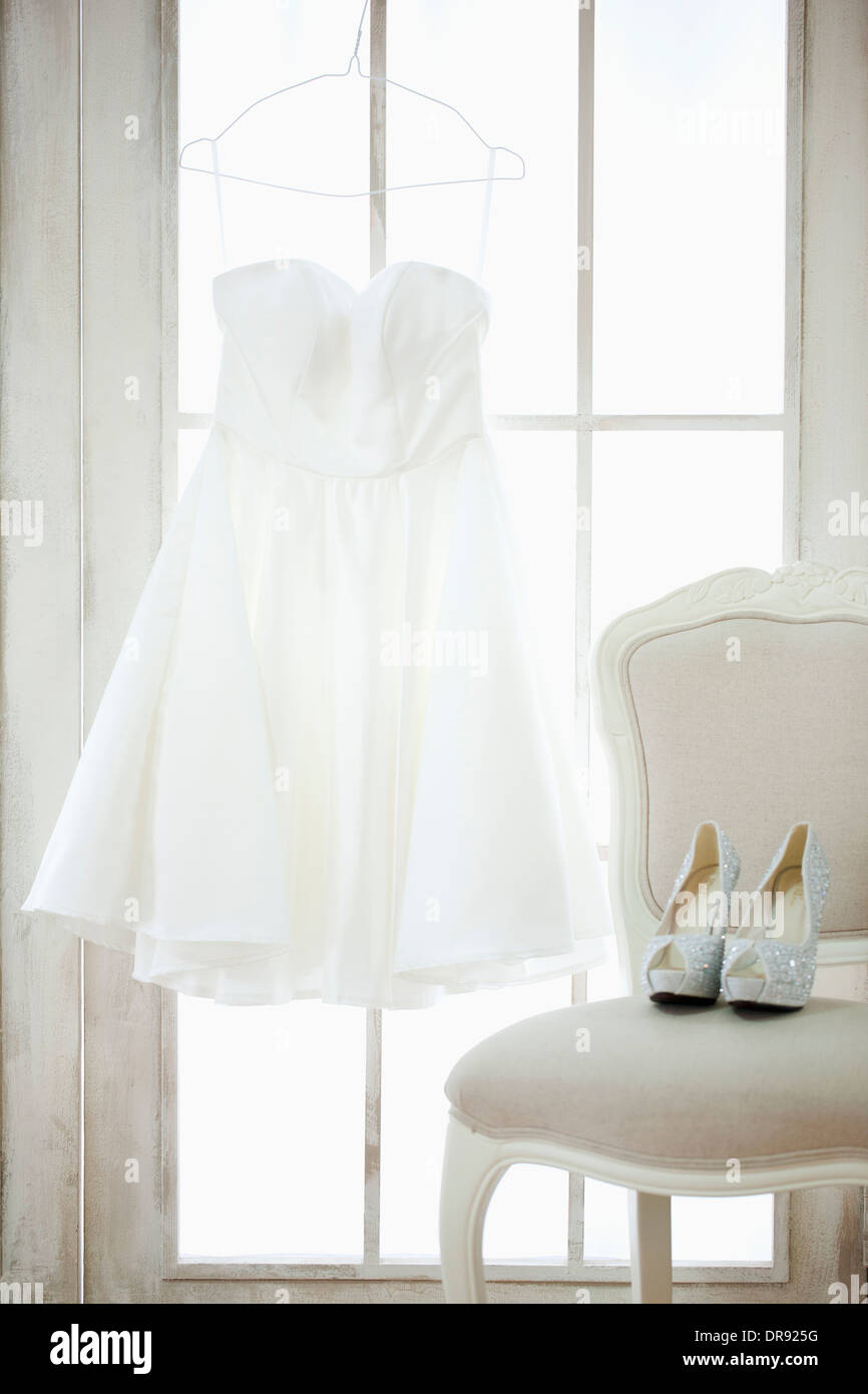 wedding dress hanging in bride's room Stock Photo - Alamy