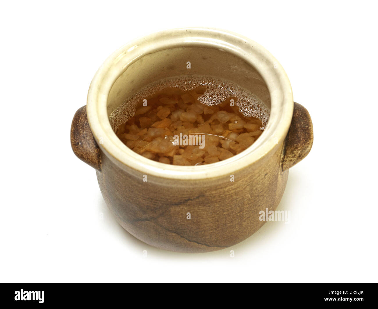 Unsolidified fresh lard with pork scratchings in earthen bowl on white background Stock Photo