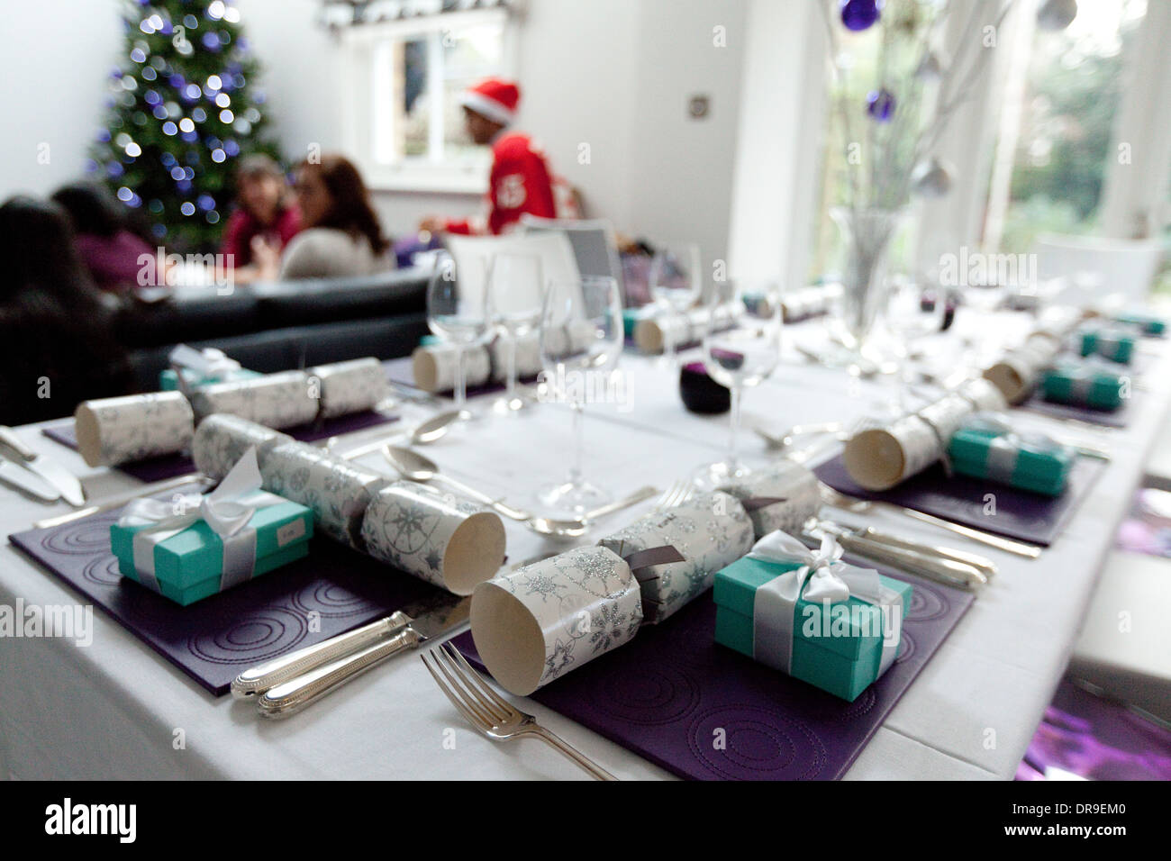Christmas Dinner table set for christmas with decorations and crackers in a UK house, UK Stock Photo