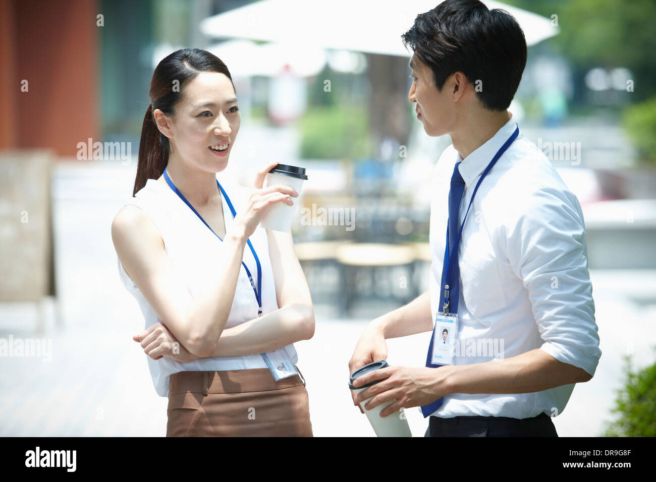 a business man and a business woman talking to each other Stock Photo ...