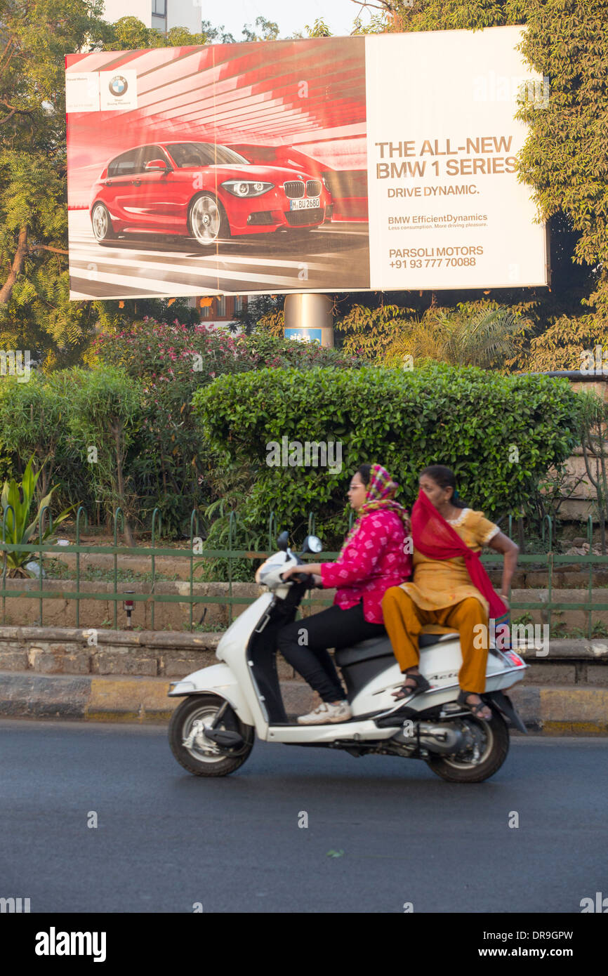 An advert for BMW cars in Ahmedabad; India, contrasting with the poor of the city. Stock Photo