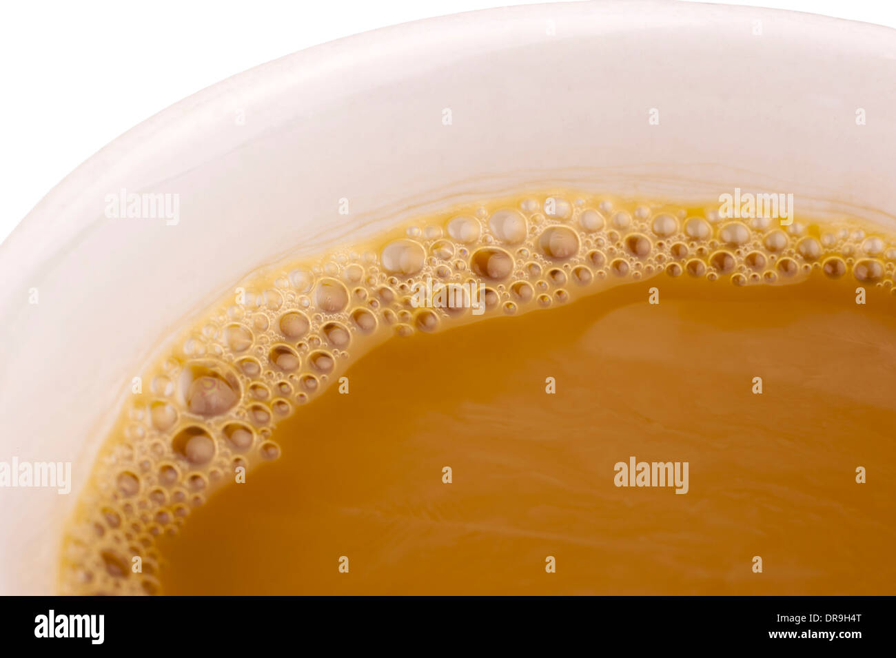 Cup of coffee with creamer and bubbles in close up Stock Photo Alamy