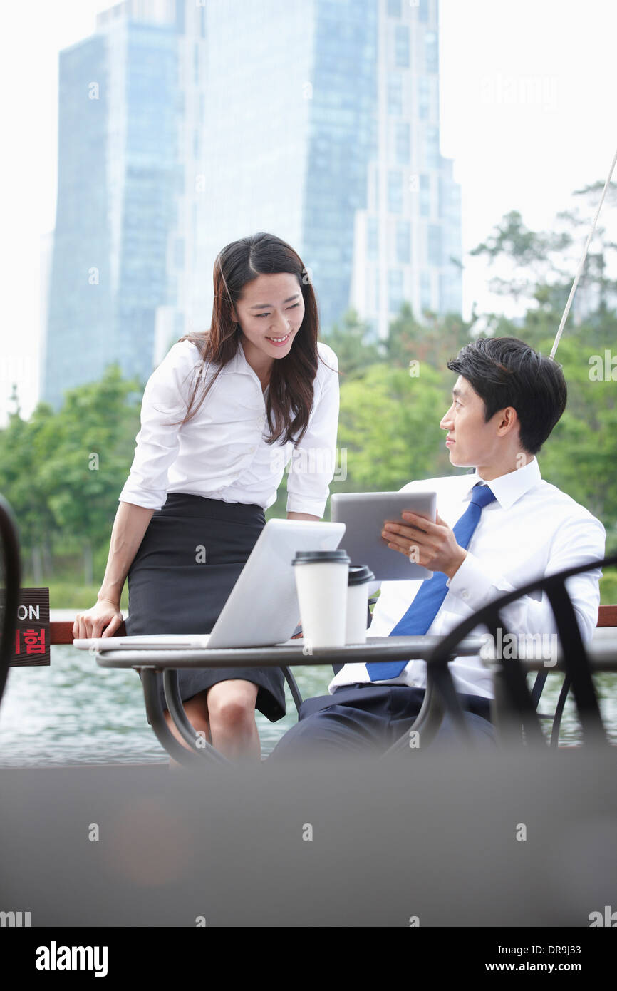 a business man and a business woman talking to each other Stock Photo ...