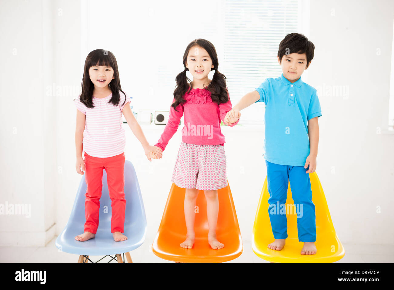 kids-standing-on-chairs-stock-photo-alamy