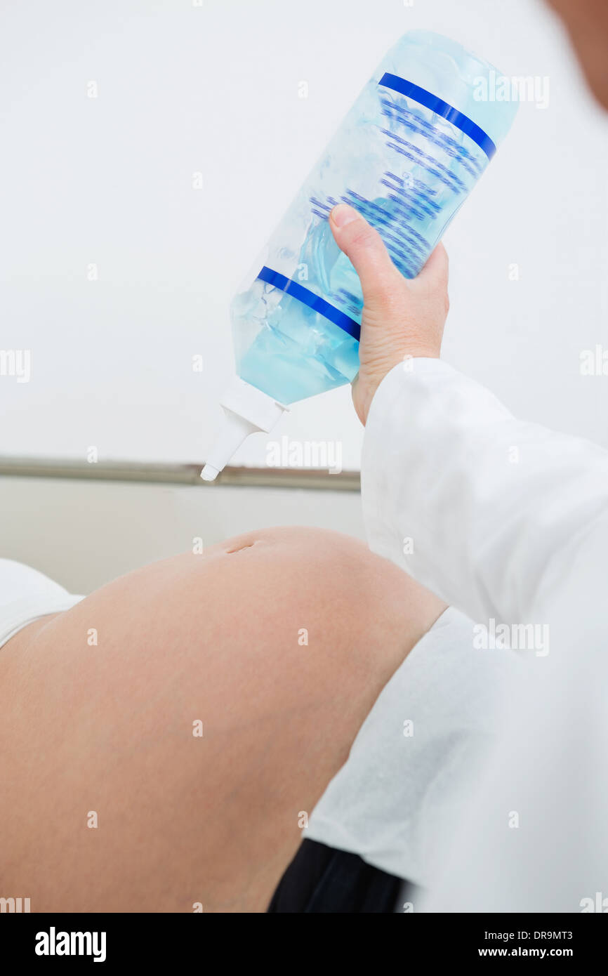 Gynecologist Applying Ultrasound Gel On Pregnant Woman's Belly Stock