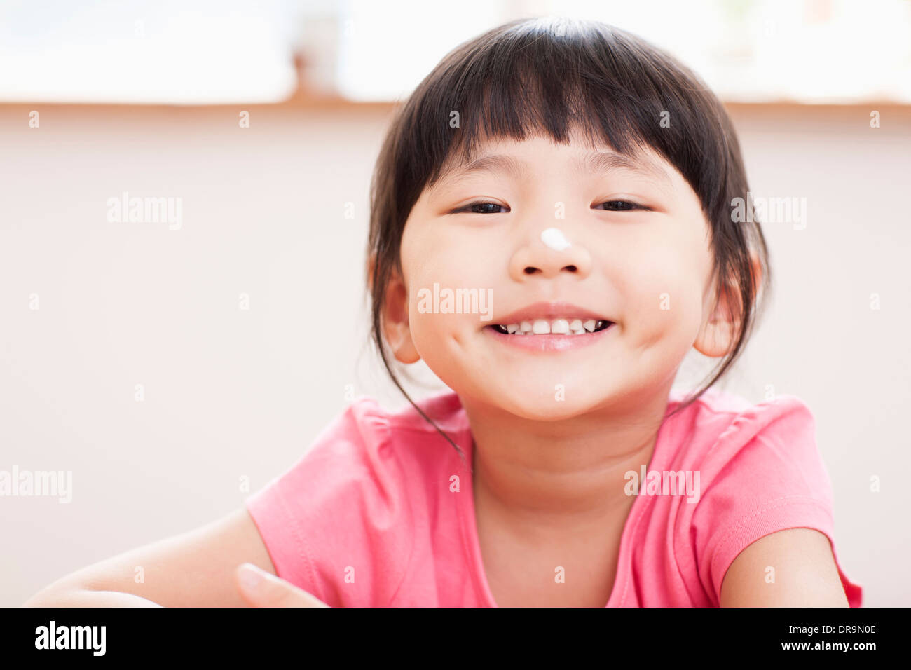 Smiling girl sitting table hi-res stock photography and images - Alamy