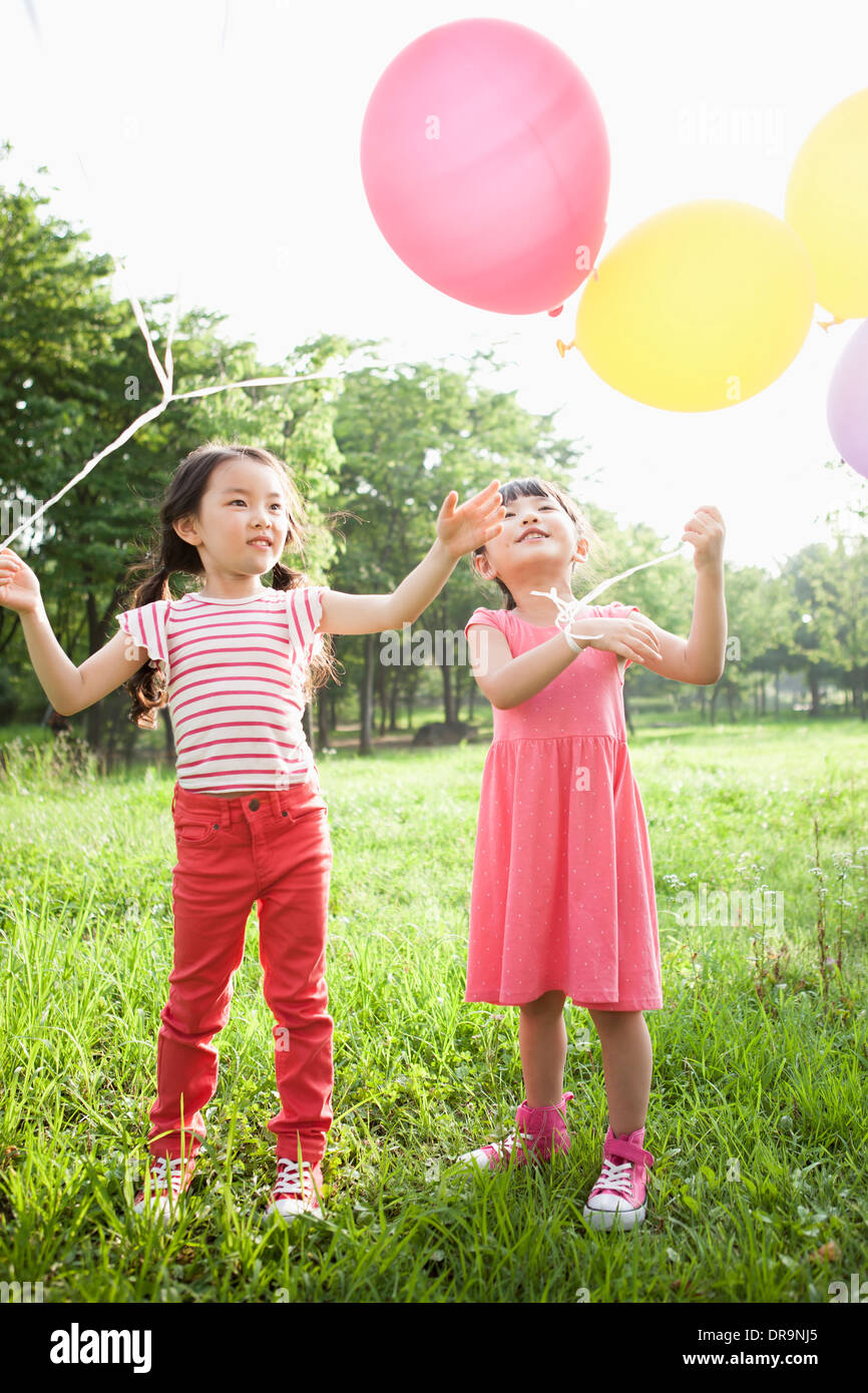 kids playing with balloons Stock Photo