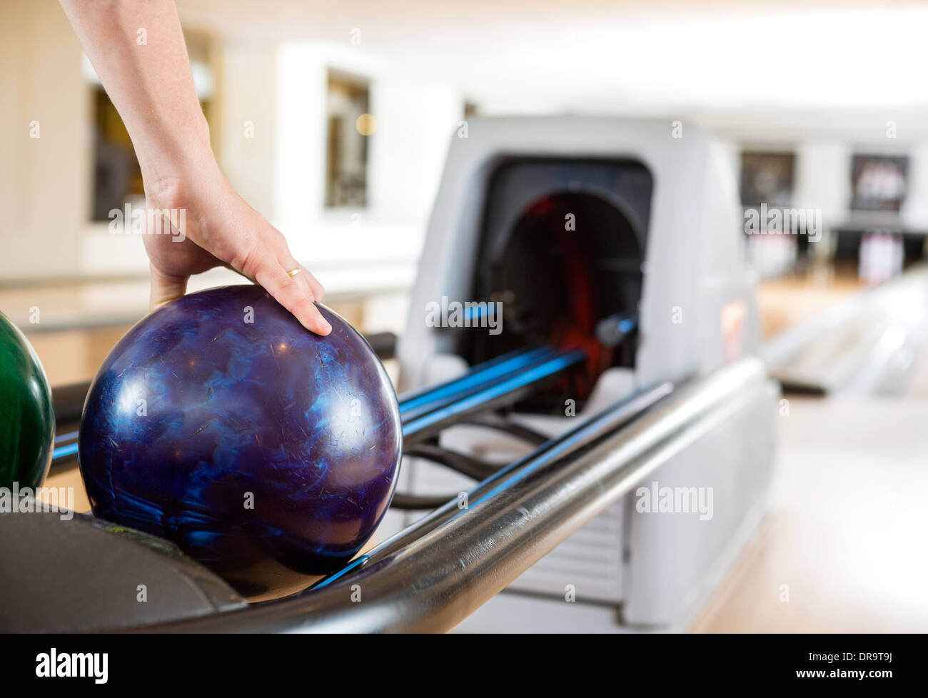 Man's Hand Picking Up Bowling Ball From Rack Stock Photo Alamy