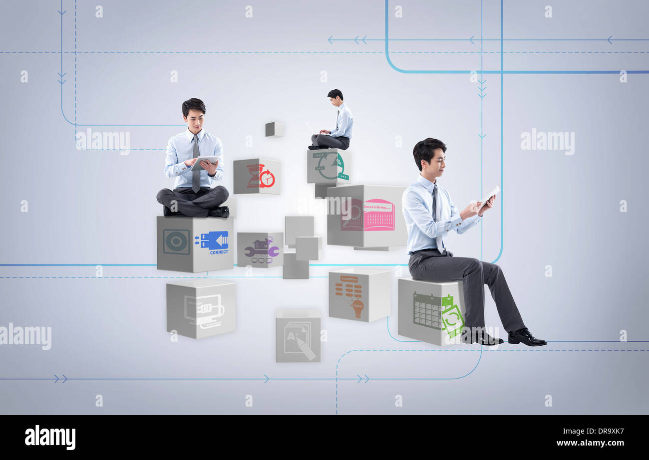 businessmen sitting on icon cubes Stock Photo
