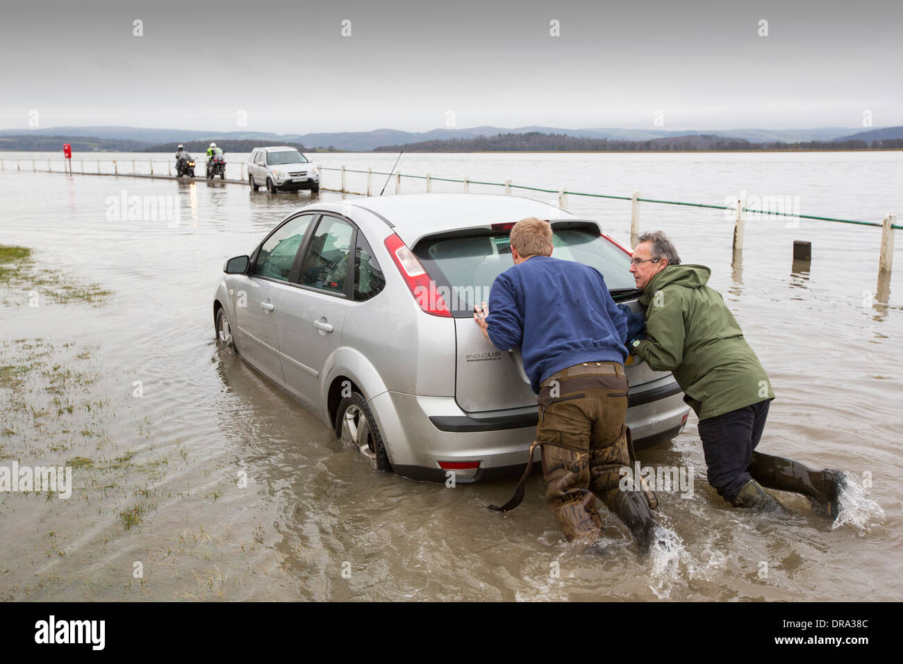 A Car in the flood waters on the road at Storth on the Kent Estuary in Cumbria, UK, during the January 2014 storms Stock Photo