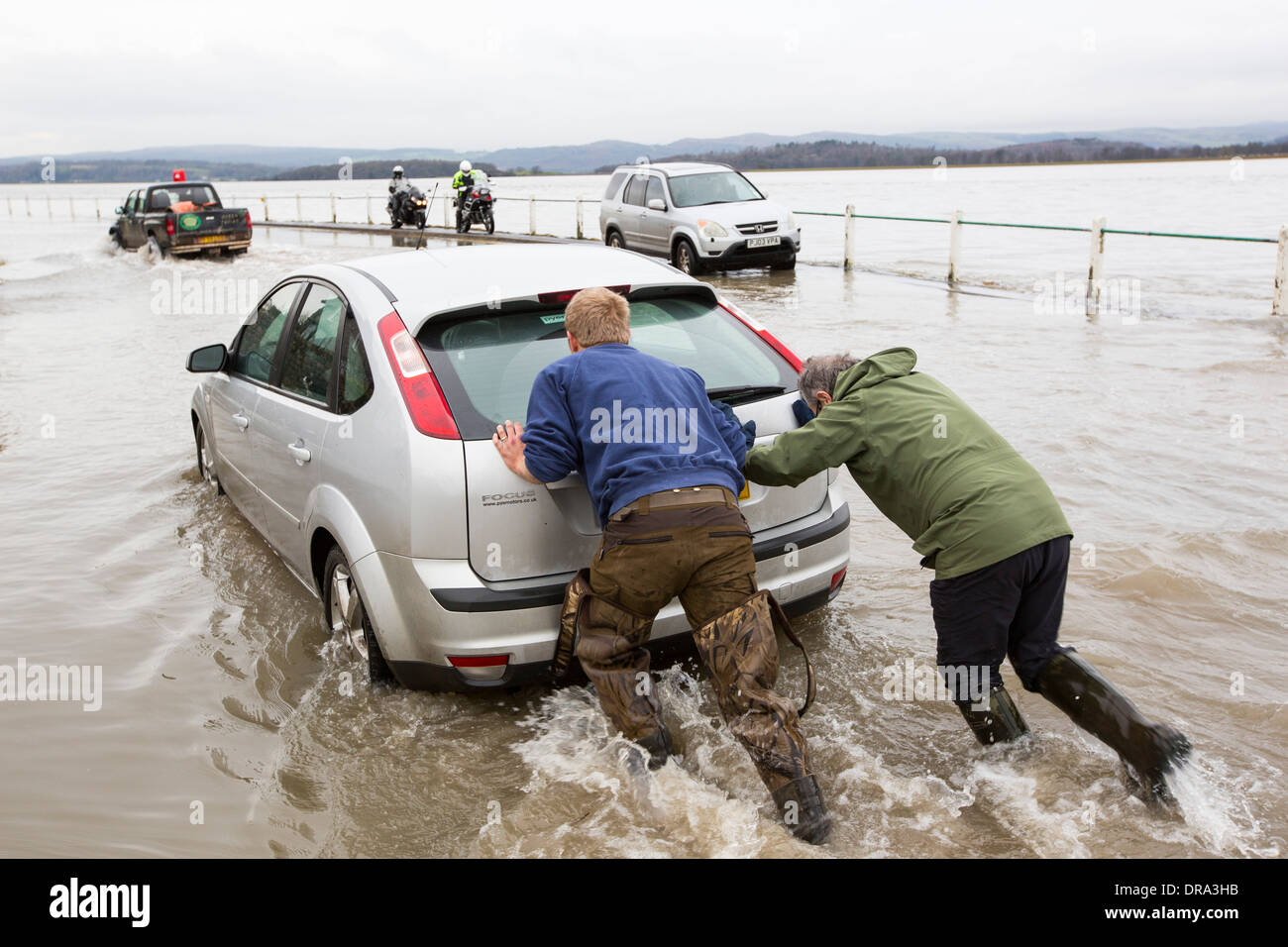 A Car in the flood waters on the road at Storth on the Kent Estuary in Cumbria, UK, during the January 2014 storms Stock Photo