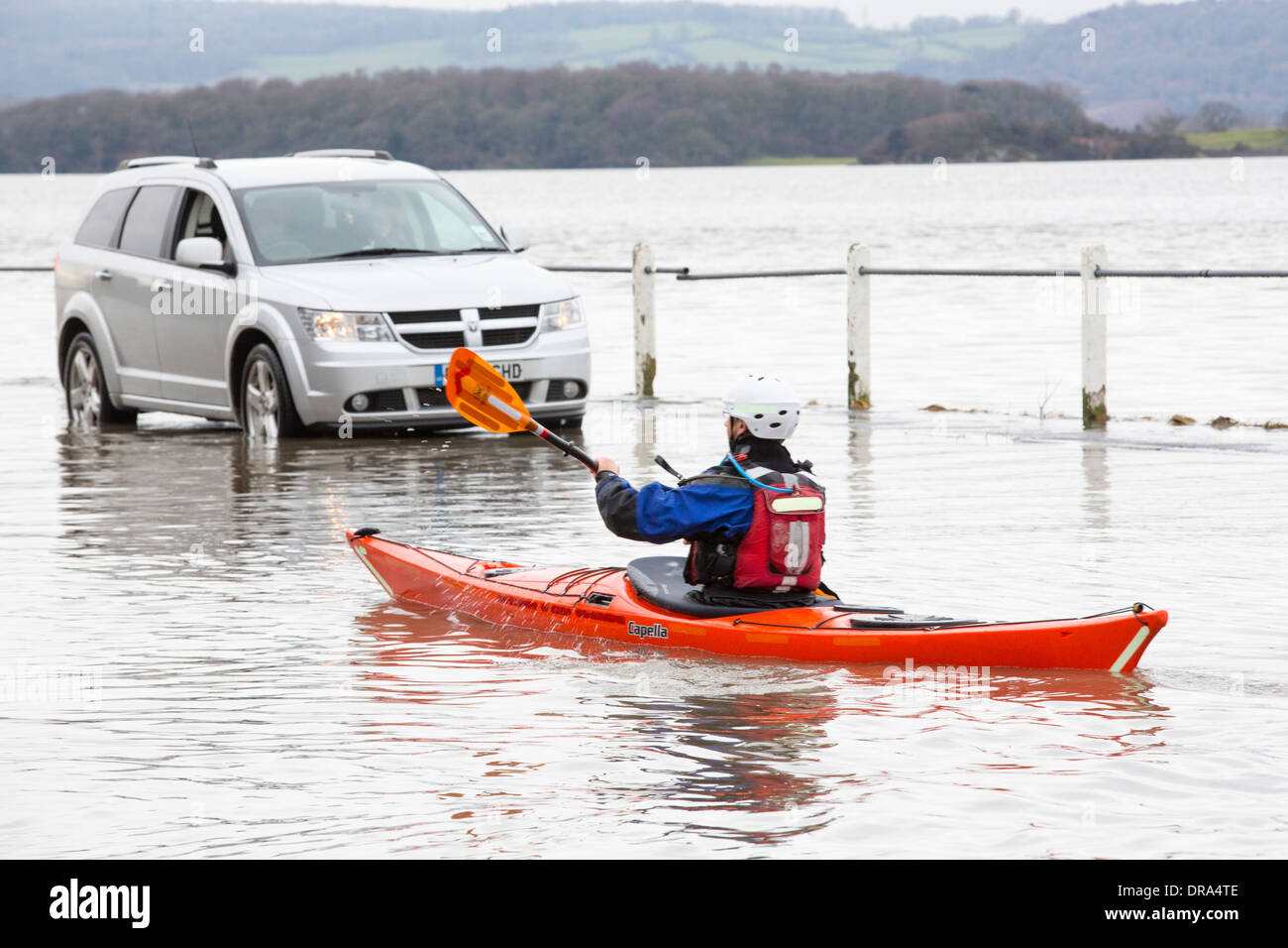 Kayakers in the flood waters on the road at Storth on the Kent Estuary in Cumbria, UK, during the January 2014 storms Stock Photo