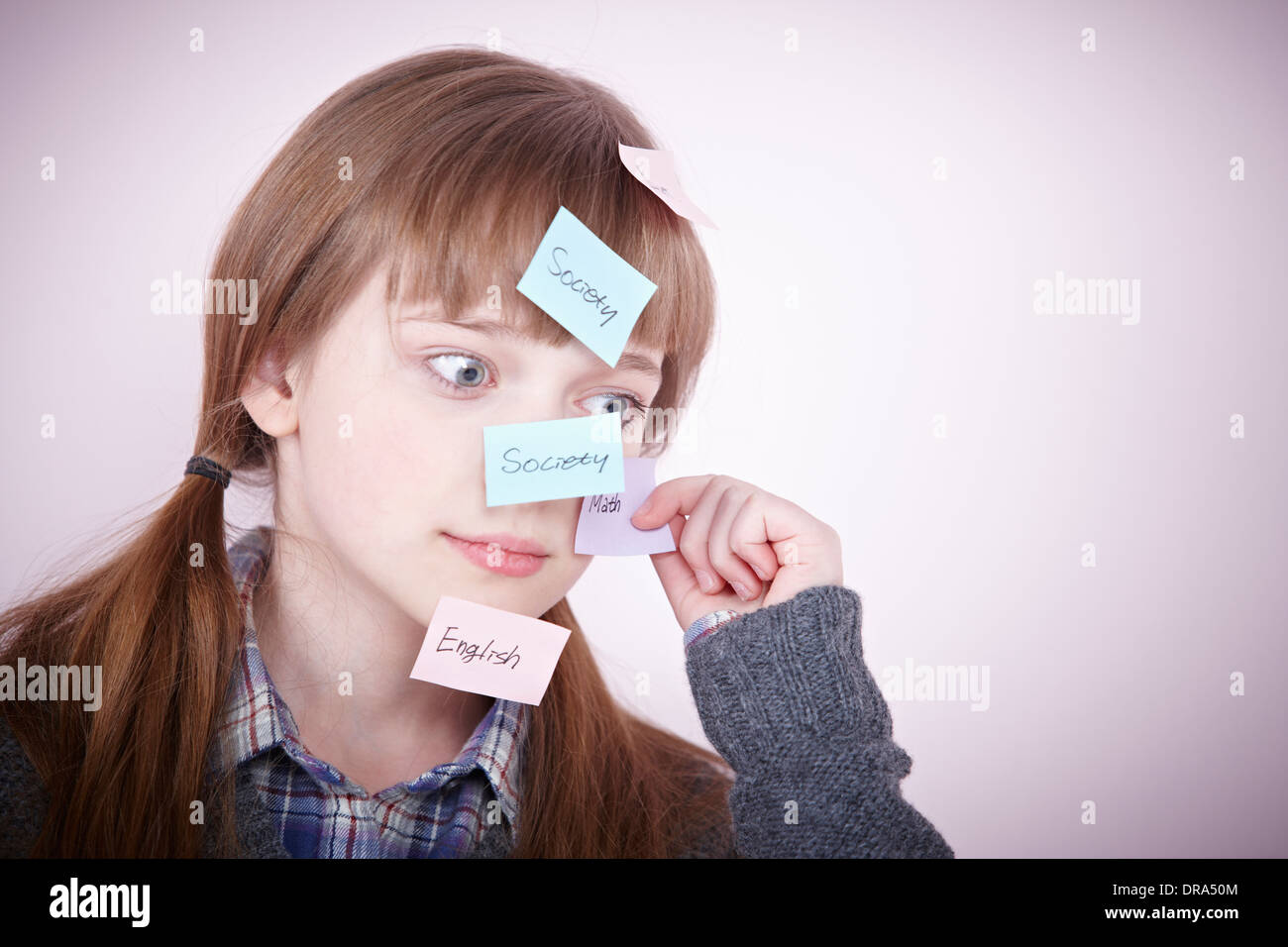 a girl with post-it notes all over her head Stock Photo