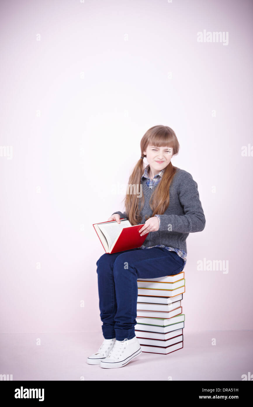 Woman sitting on pile books hi-res stock photography and images - Alamy