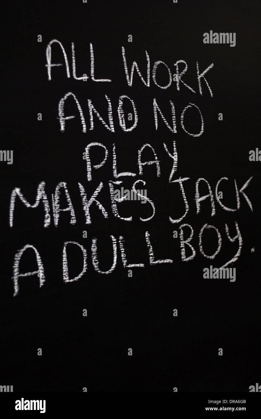 chalk writing- All work and no play makes jack a dull boy - words written on blackboard. Stock Photo
