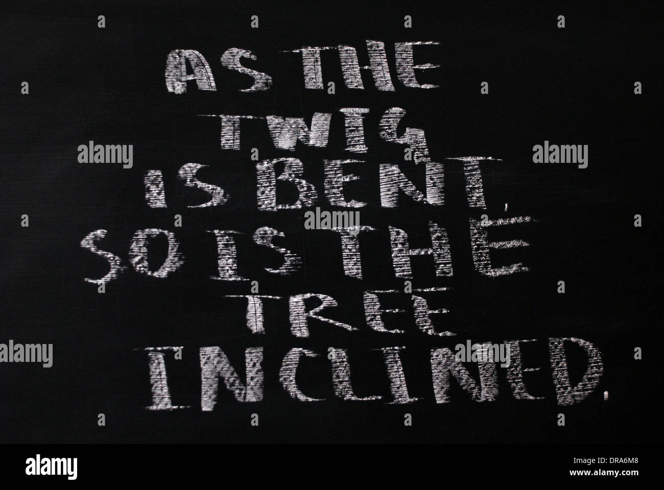 chalk writing - As the twig is bent, so is the tree inclined.- words ...