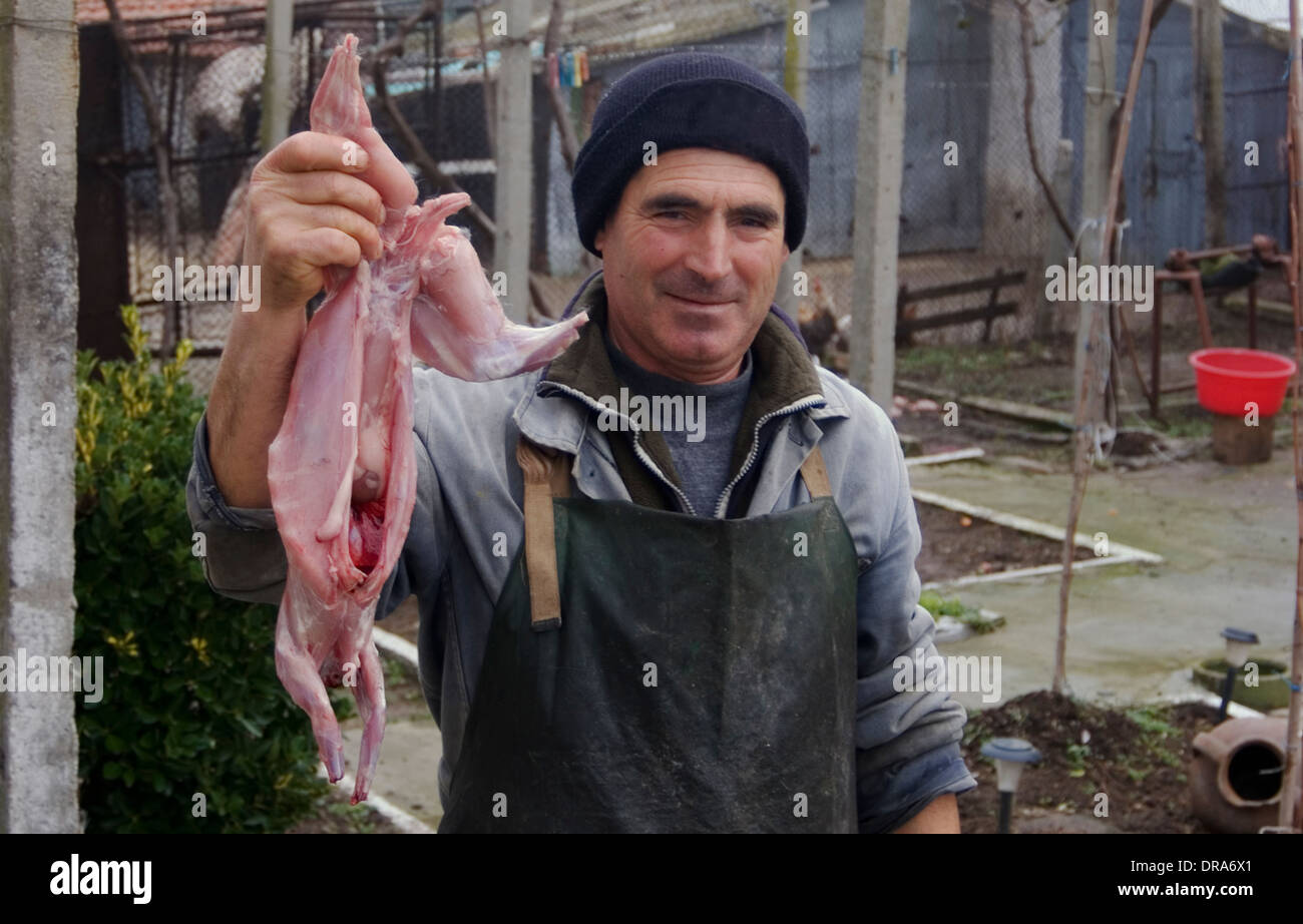 Malomirovo village mayor with his freshly skinned rabbit for an evening ...