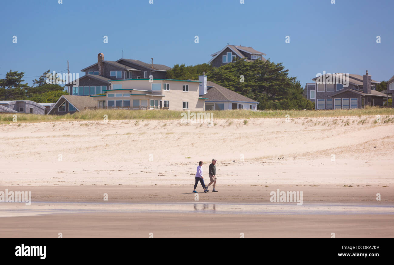 MANZANITA, OREGON, USA - Couple walking on beach on the Oregon coast. Stock Photo