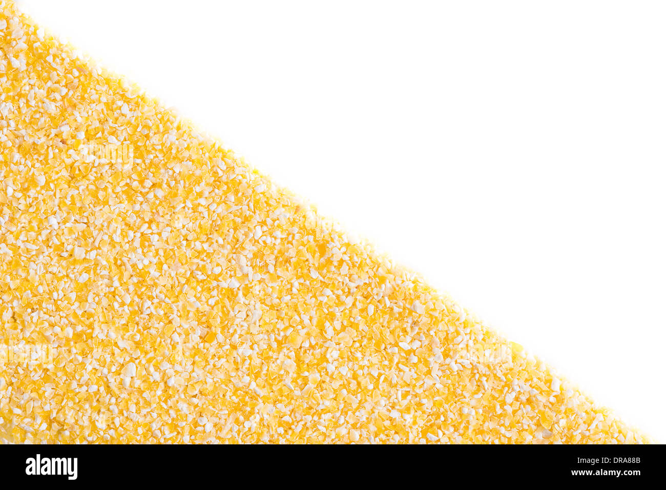 Corn grits on white background, diagonal split. Stock Photo