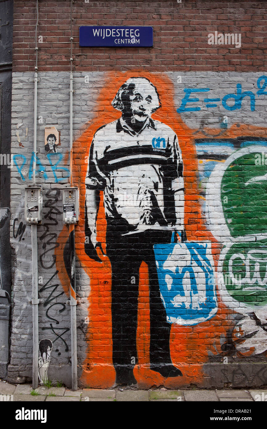 Albert Einstein holding a bag, graffiti on a brick building facade in Amsterdam, Holland, Netherlands. Stock Photo