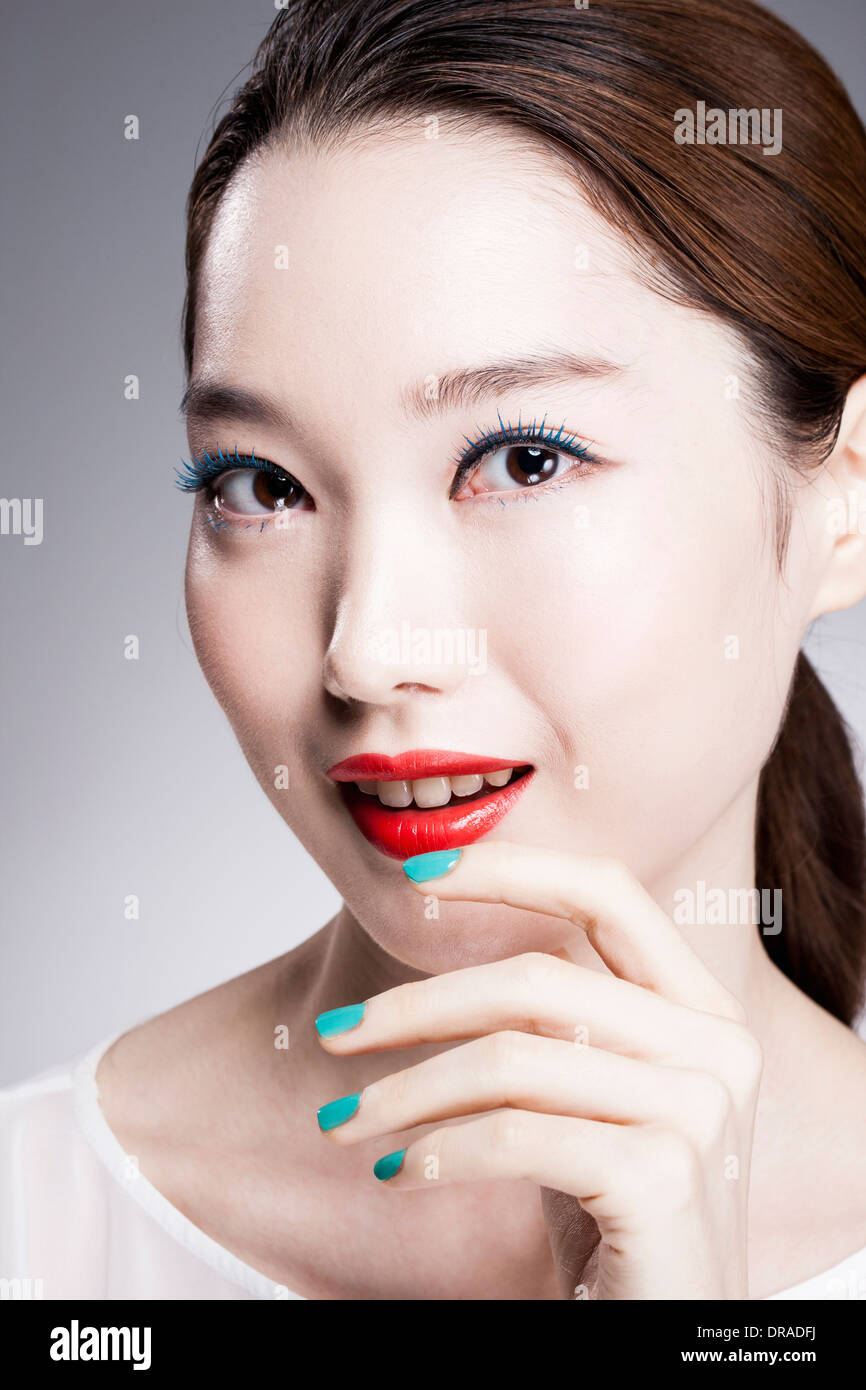 close up shot of a woman in red lipsticks and white top Stock Photo
