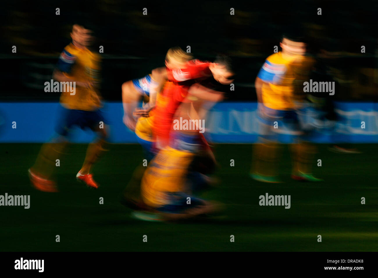 Blurred football players in red and yellow. Stock Photo