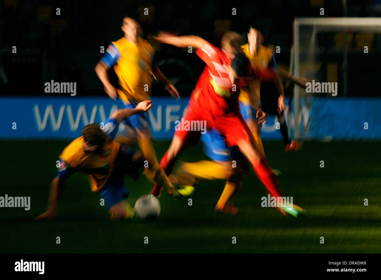Blurred football players in red and yellow. Stock Photo