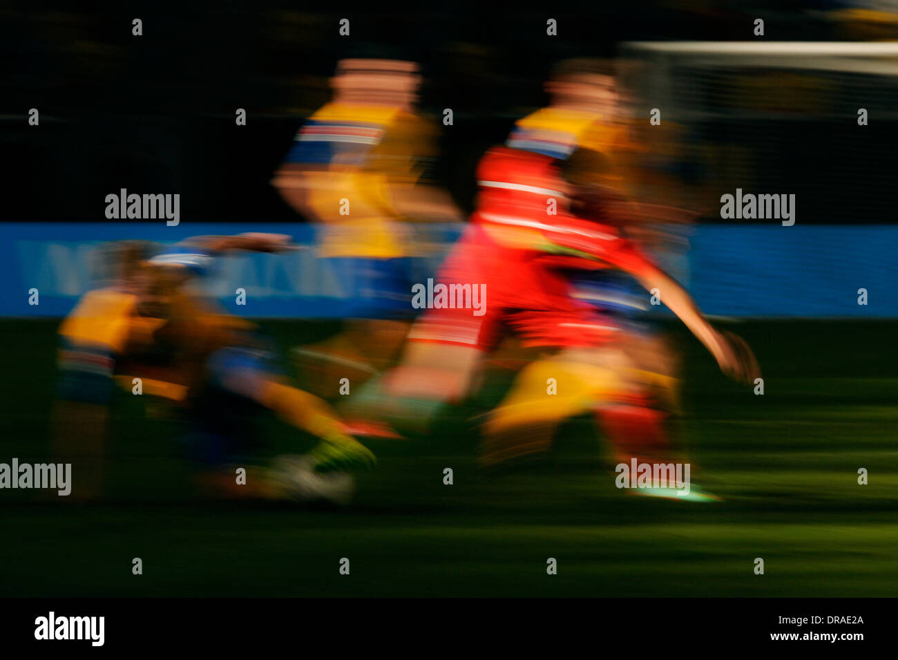 Blurred football players in red and yellow. Stock Photo