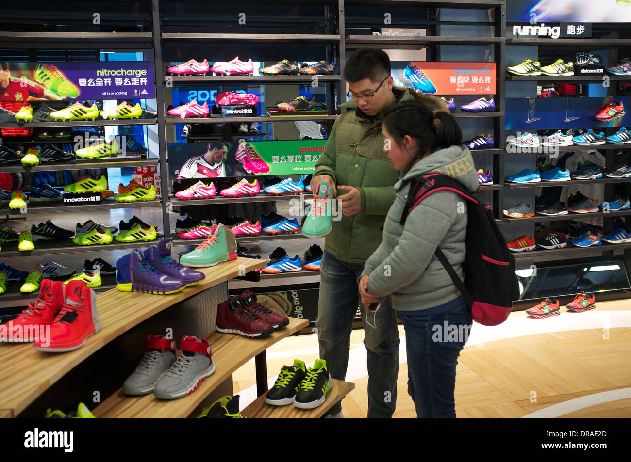 People shop at Adidas outlet in Beijing, China. 21-Jan-2014 Stock Photo -  Alamy