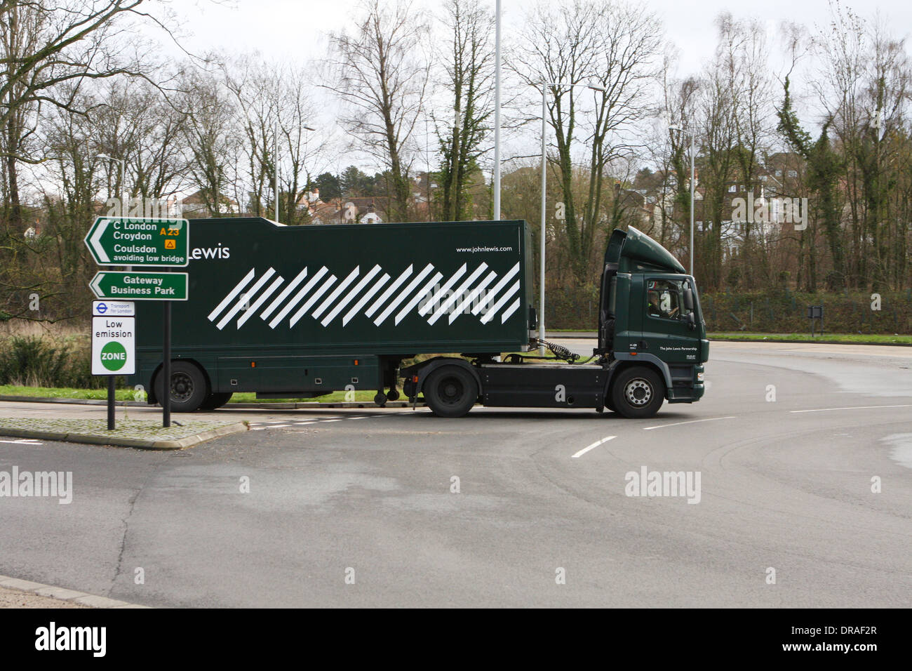 An articulated John Lewis truck entering a roundabout in Coulsdon, Surrey, England Stock Photo