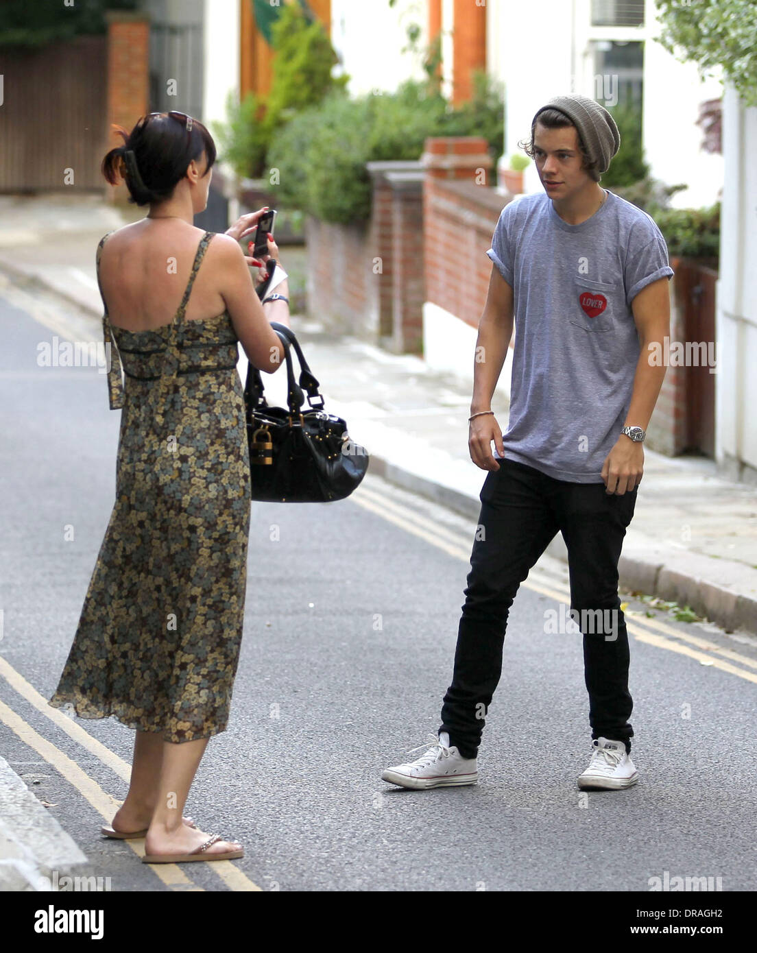 Harry Styles of One Direction seen out and about in Hampstead with friends.  He signed autographs and posed for photographs for fans. London, England -  05.07.12 Stock Photo - Alamy