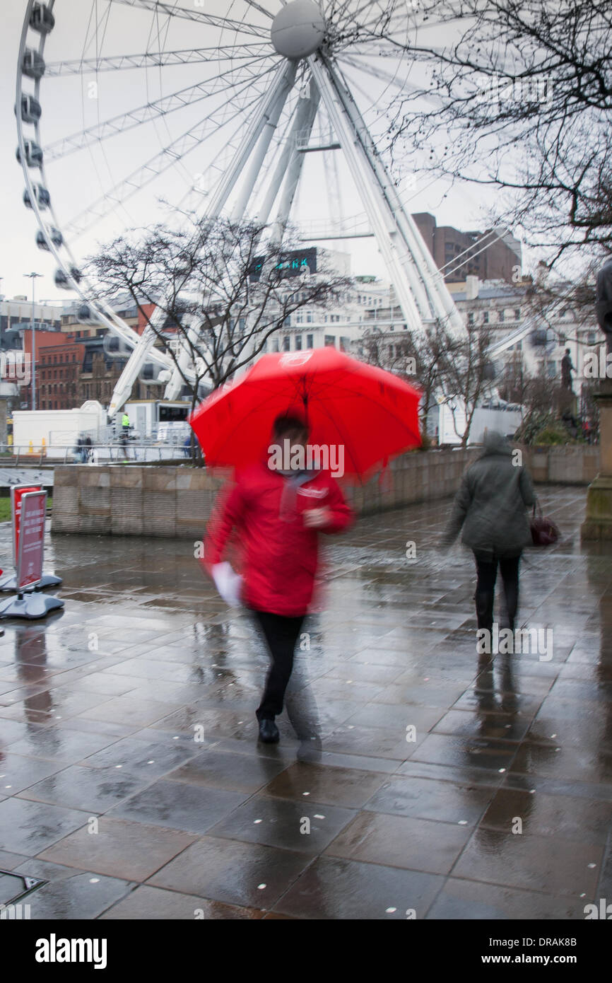 Manchester UK Piccadilly. 22nd January, 2014.  Wet damp day for the Sun Big Smile 2014.  NEW Year, new Big Smile. The Sun Big Smile 2014 Smile Squad, in Piccadilly Gardens where The Sun launches “January blues-busting” Big Smile Giveaway campaign on what is said to be the most depressing day of the year. Credit:  Mar Photographics/Alamy Live News. Stock Photo
