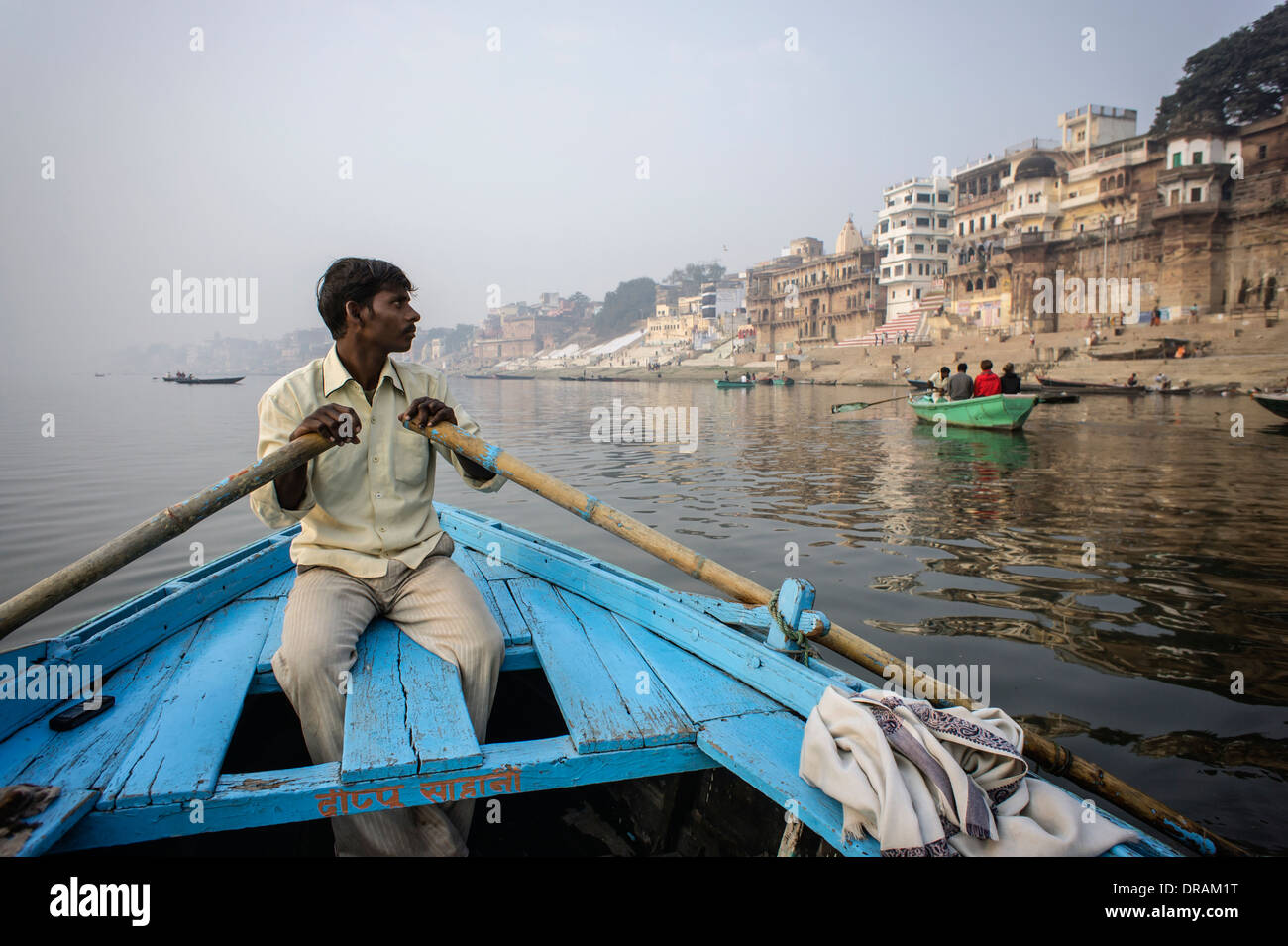 Man rowing boat on the Ganges River Stock Photo