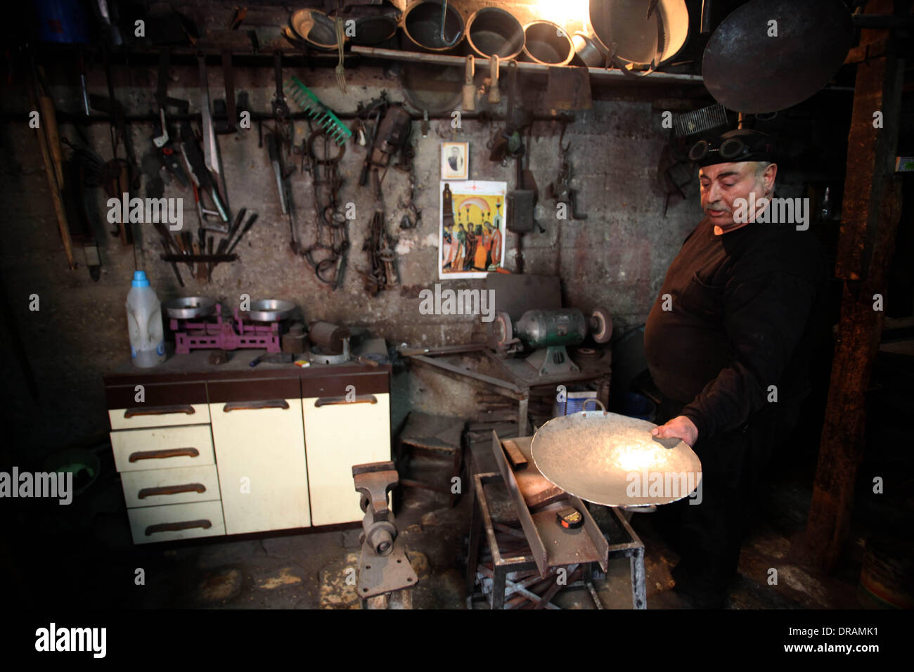 Tarshiha, Acre, Palestinian Territory. 21st Jan, 2014. A Palestinian blacksmith works at his workshop in the village of Tarshiha, north Acre on January 21, 2014. Tarshiha was in the territory allotted to the Arab state under the 1947 UN Partition Plan. However, in the 1948 Arab-Israeli War, the village was captured by the Israel forces in operation Hiram on October 29. The village was bombed by three Israeli planes on the evening of 28 October. This was followed by a prolonged artillery barrage and a further air raid in the morning with the village defenders and most of the inhabitants retrea Stock Photo