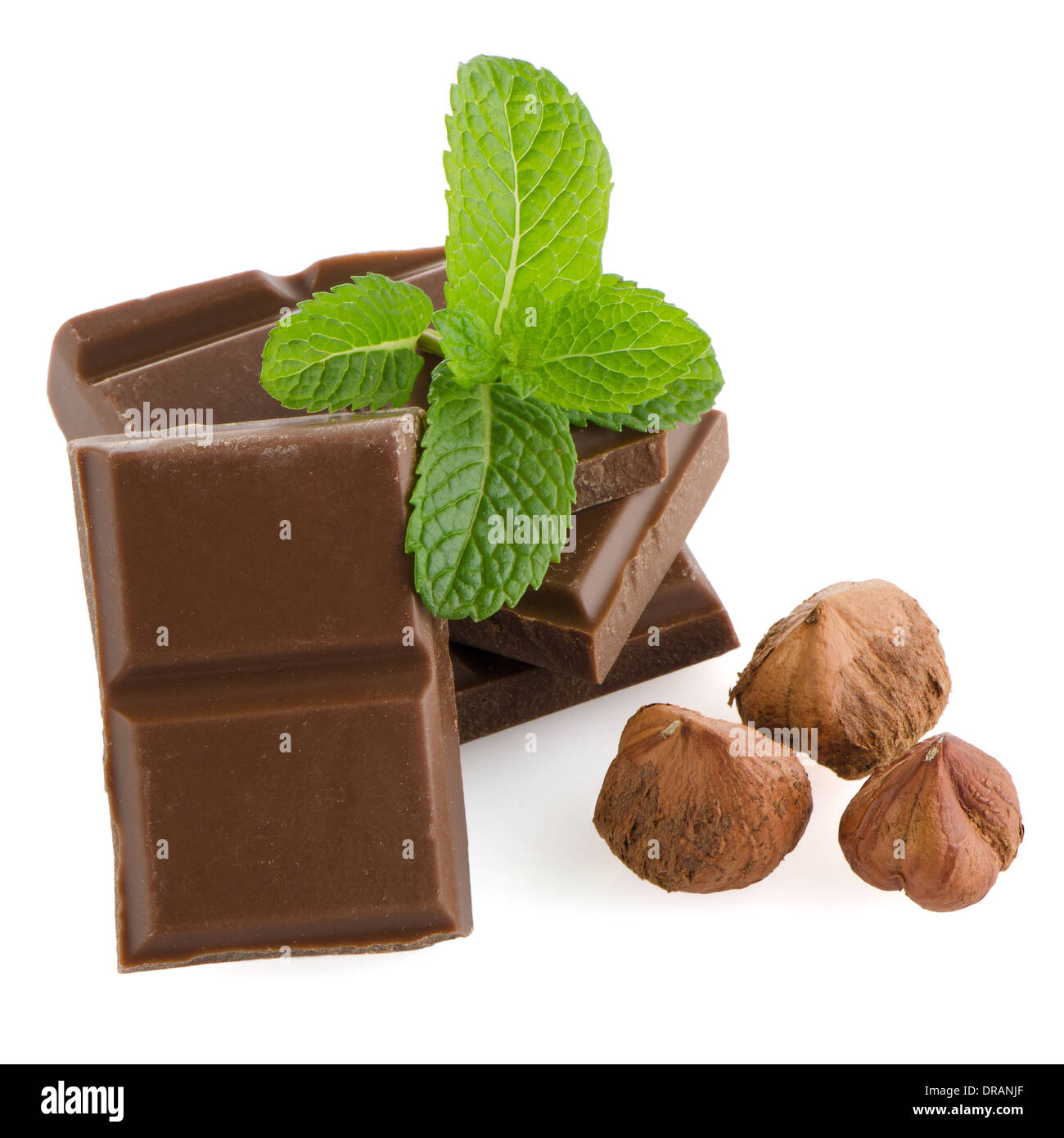 Chocolate parts and cinnamon sticks isolated on white background Stock