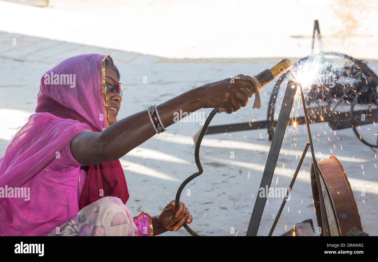 Women welding joints during the construction of solar cookers at the Barefoot College in Tilonia, Rajasthan, India. Stock Photo