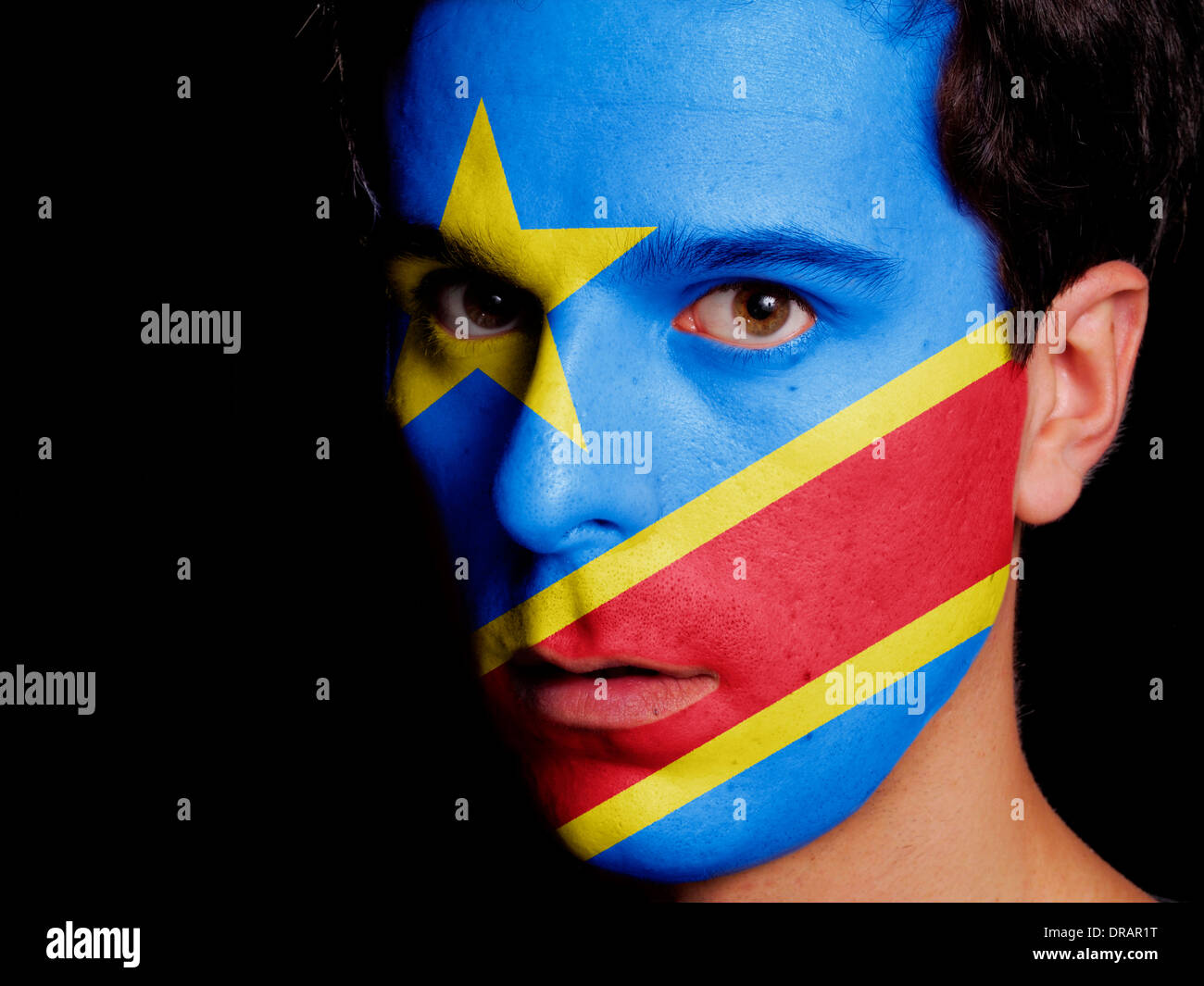 Flag of Democratic Republic of Congo Painted on a Face of a Young Man Stock Photo