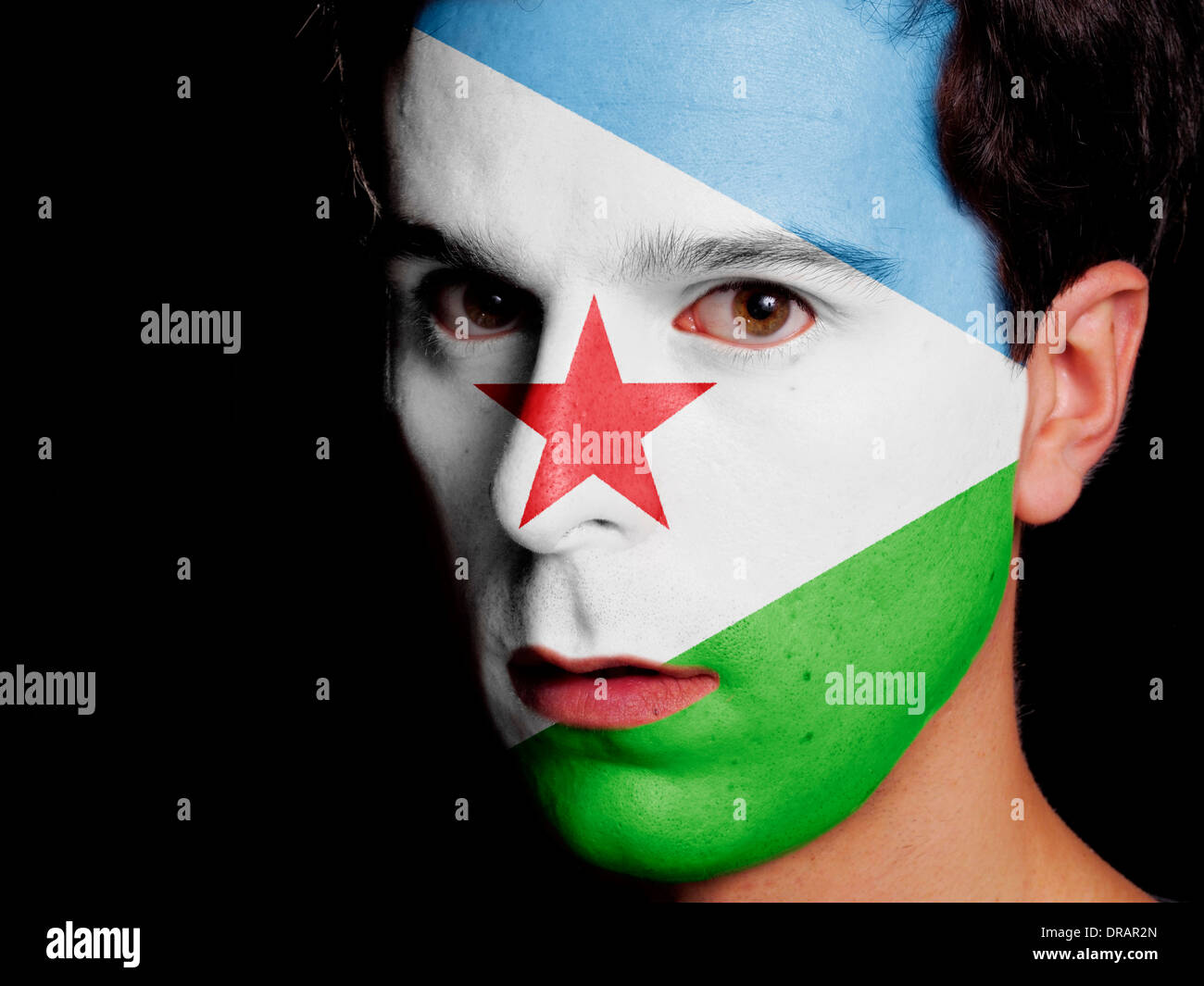 Flag of Djibouti Painted on a Face of a Young Man Stock Photo