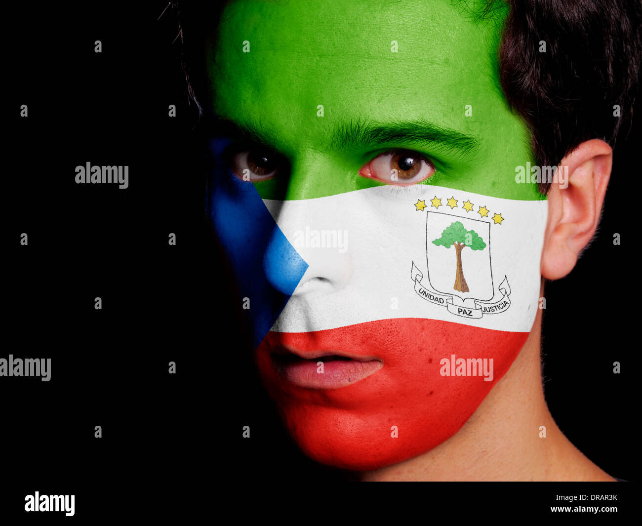 Flag of Equatorial Guinea Painted on a Face of a Young Man Stock Photo