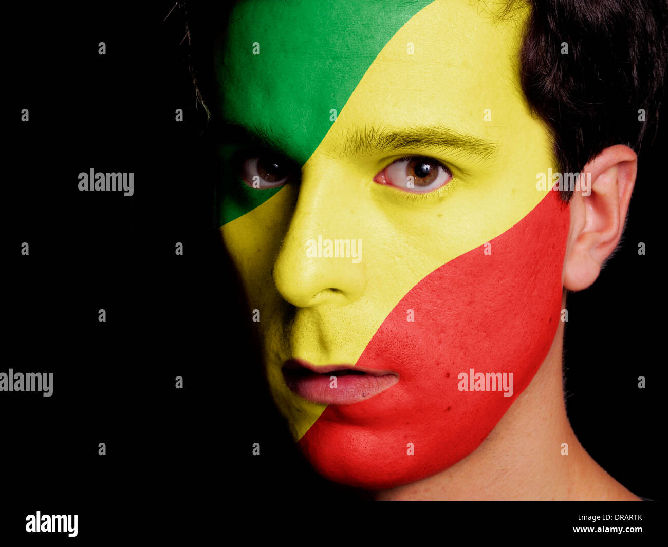 Flag of Republic of the Congo Painted on a Face of a Young Man Stock Photo