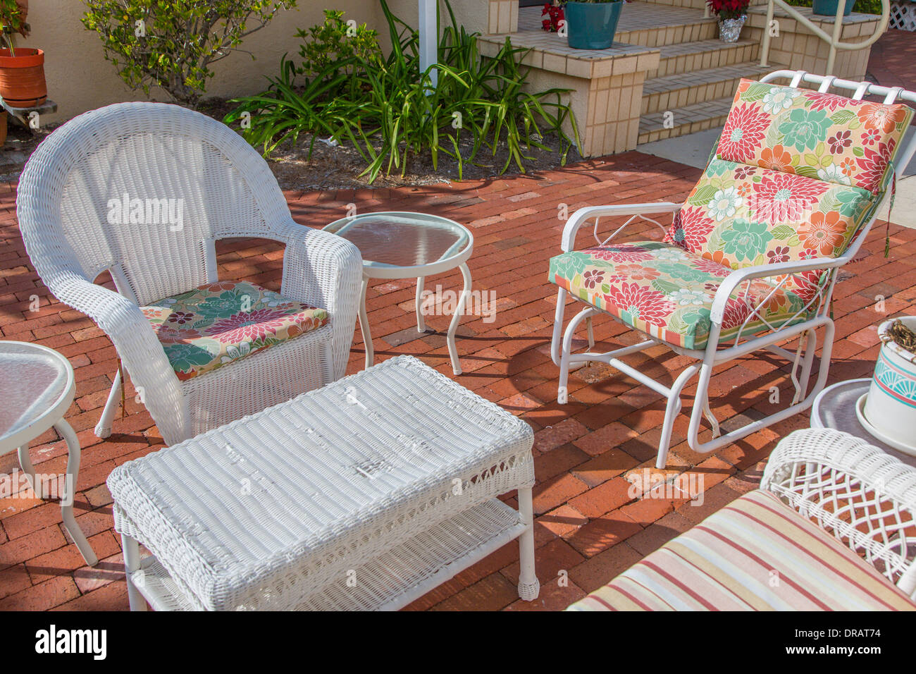 Outdoor seating area with white wicker furniture in village of Boca Grande on  Gasparilla Island Florida Stock Photo