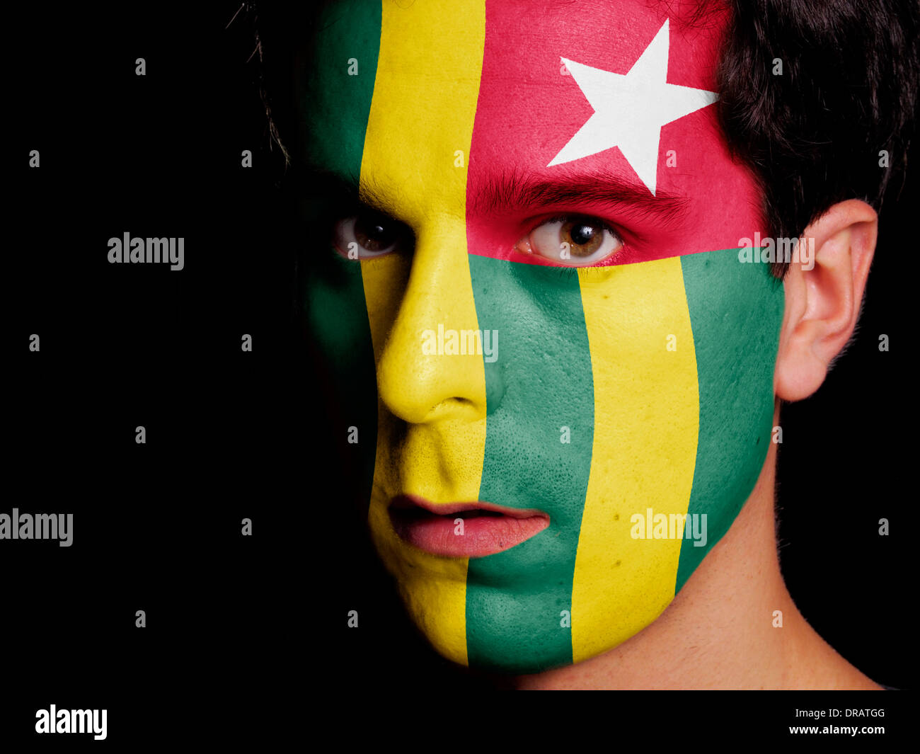 Flag of Togo Painted on a Face of a Young Man Stock Photo