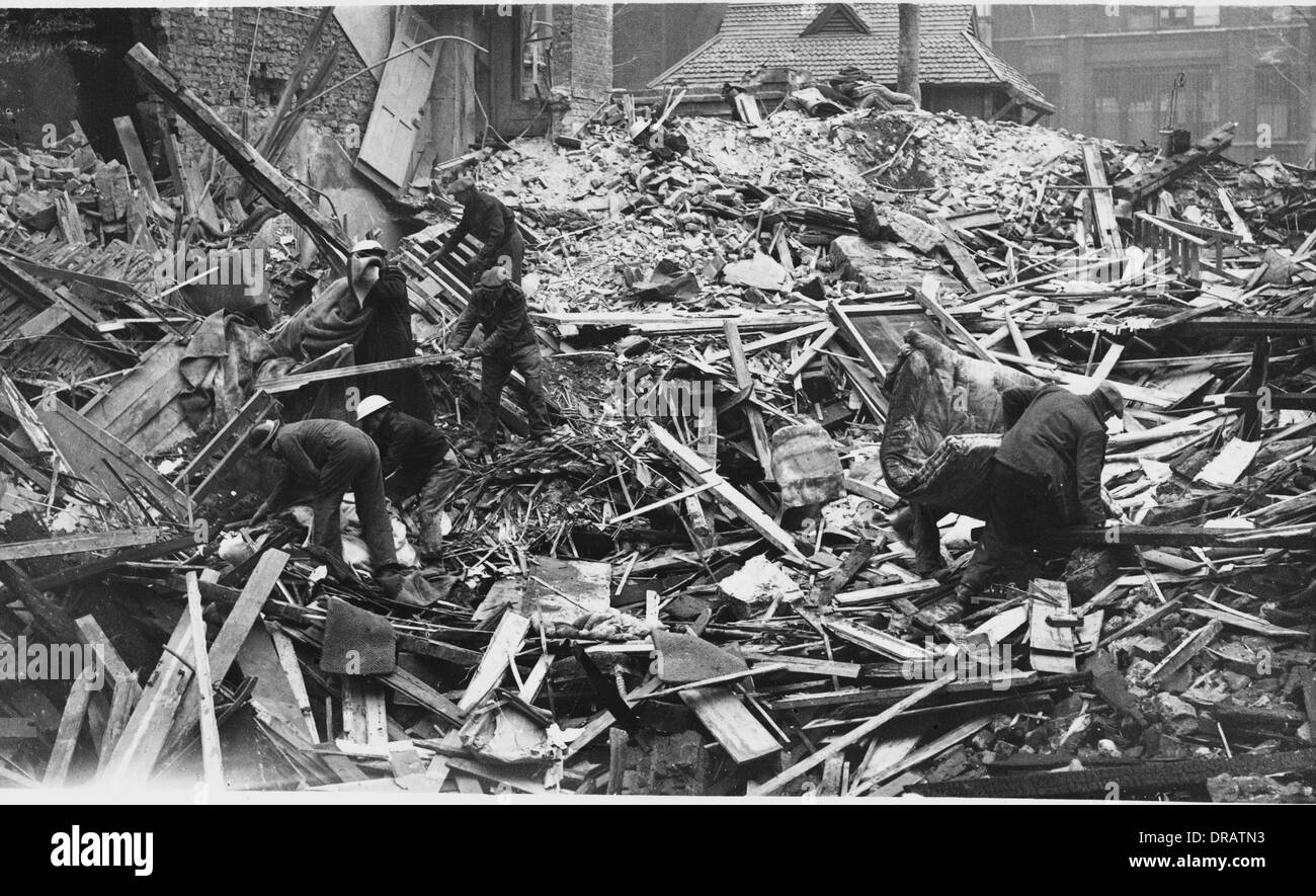 Combing the wreckage of a bombed house Stock Photo