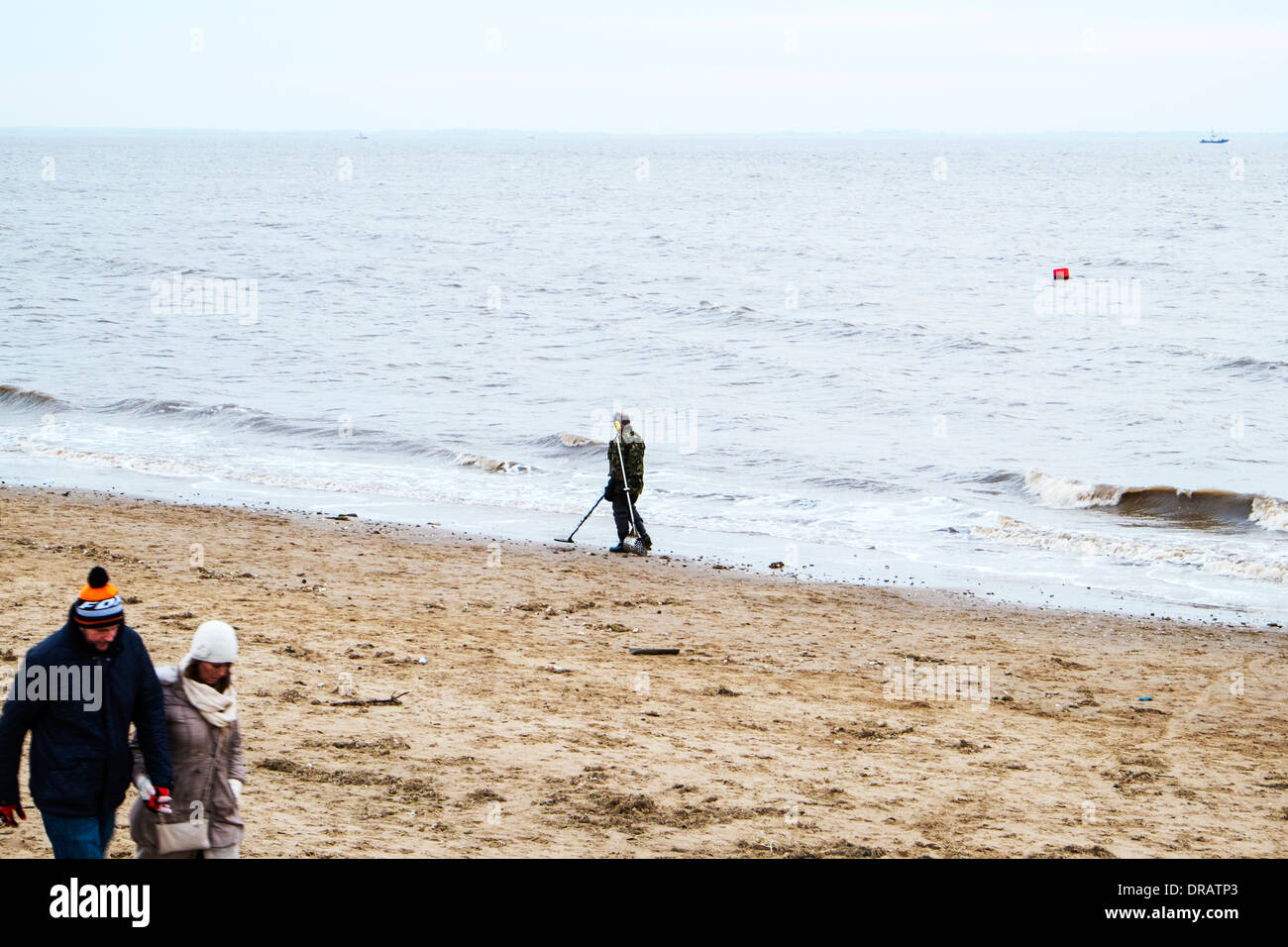 Man using metal detector on beach coast beachcomber Cleethorpes, Lincolnshire coast, UK, England Stock Photo