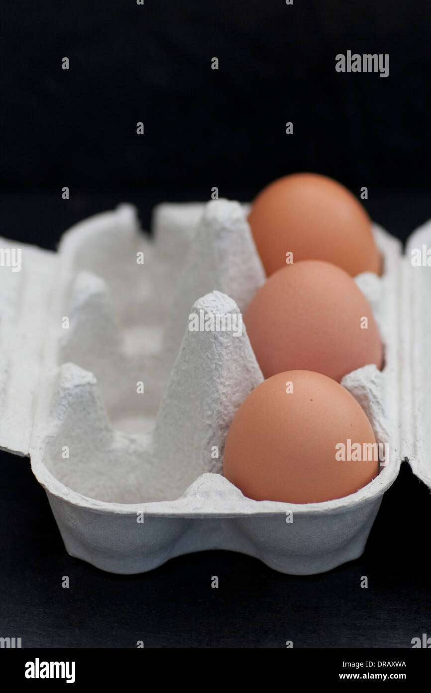 Close-up of three hen's eggs in an egg carton Stock Photo