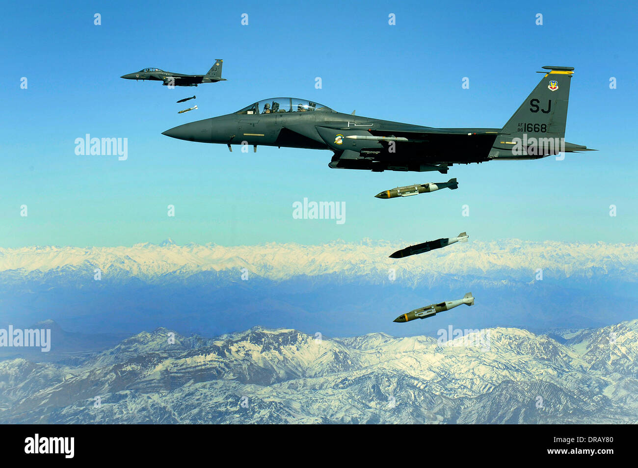 U.S. Air Force F-15E Strike Eagle aircraft drop 2,000-pound joint direct attack munitions on a cave in eastern Afghanistan Stock Photo