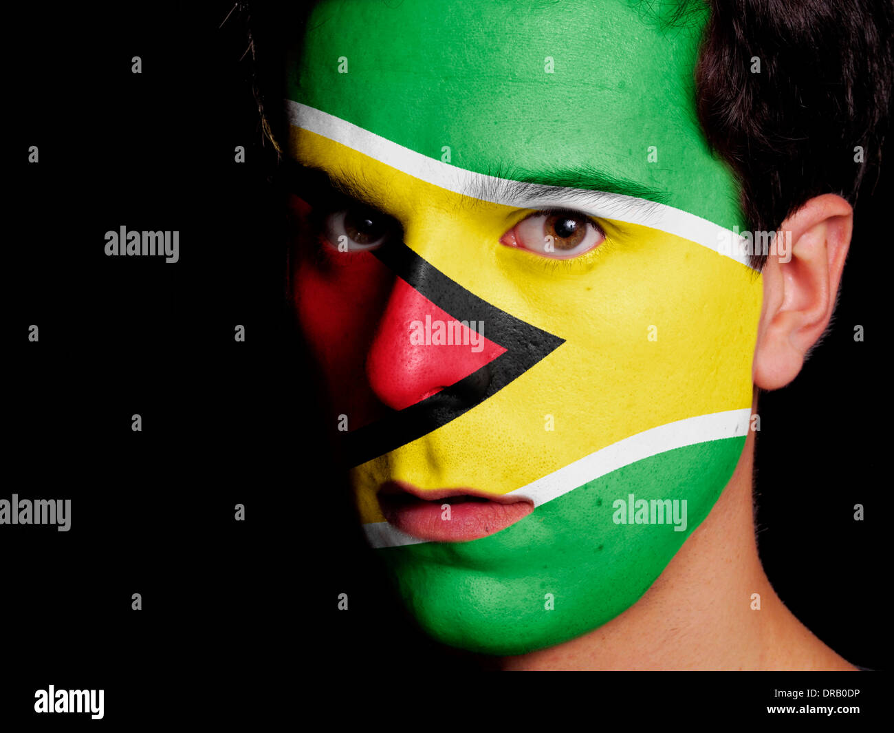 Flag of Guyana Painted on a Face of a Young Man Stock Photo