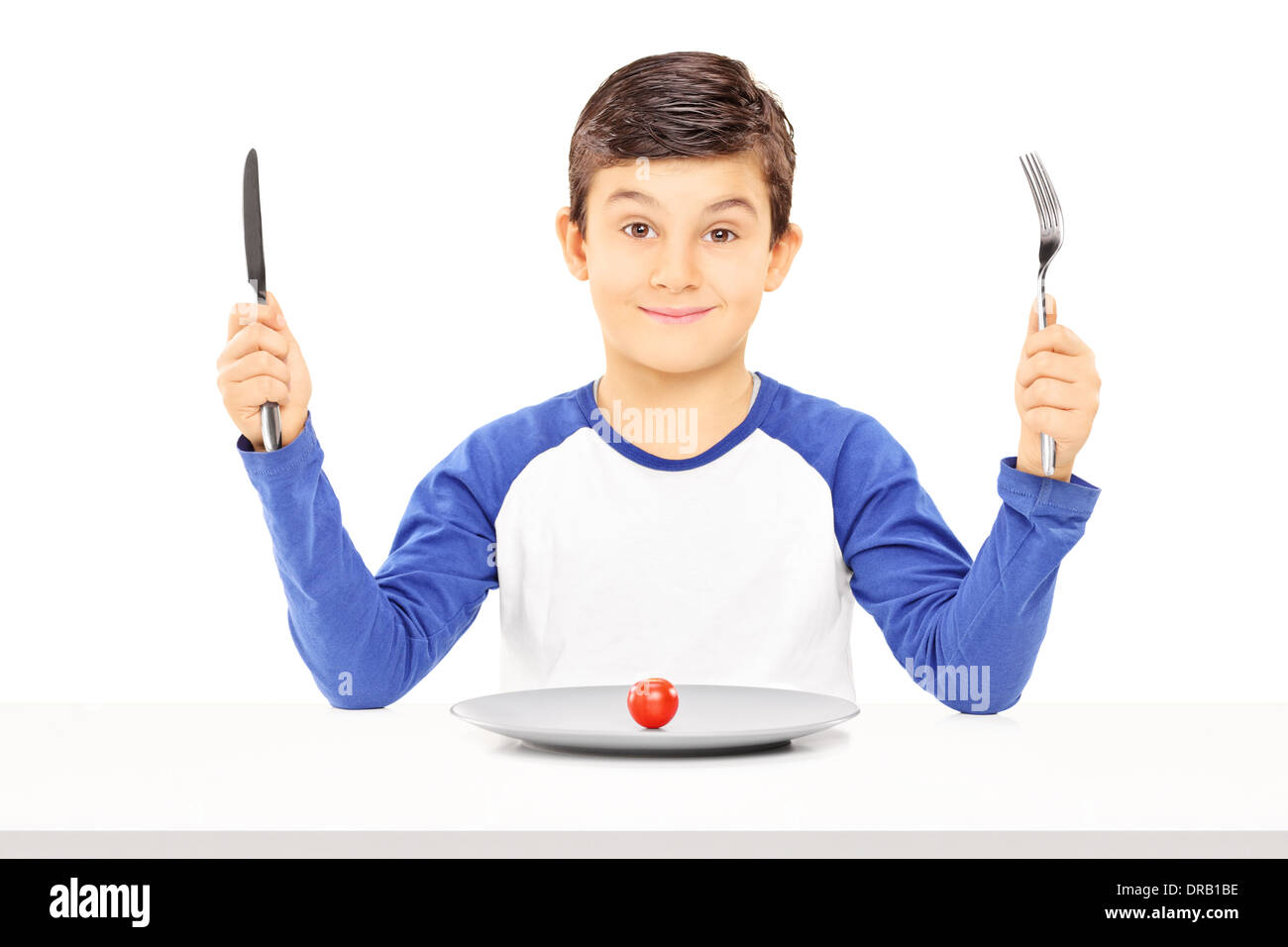Young boy holding fork knife hires stock photography and images Alamy