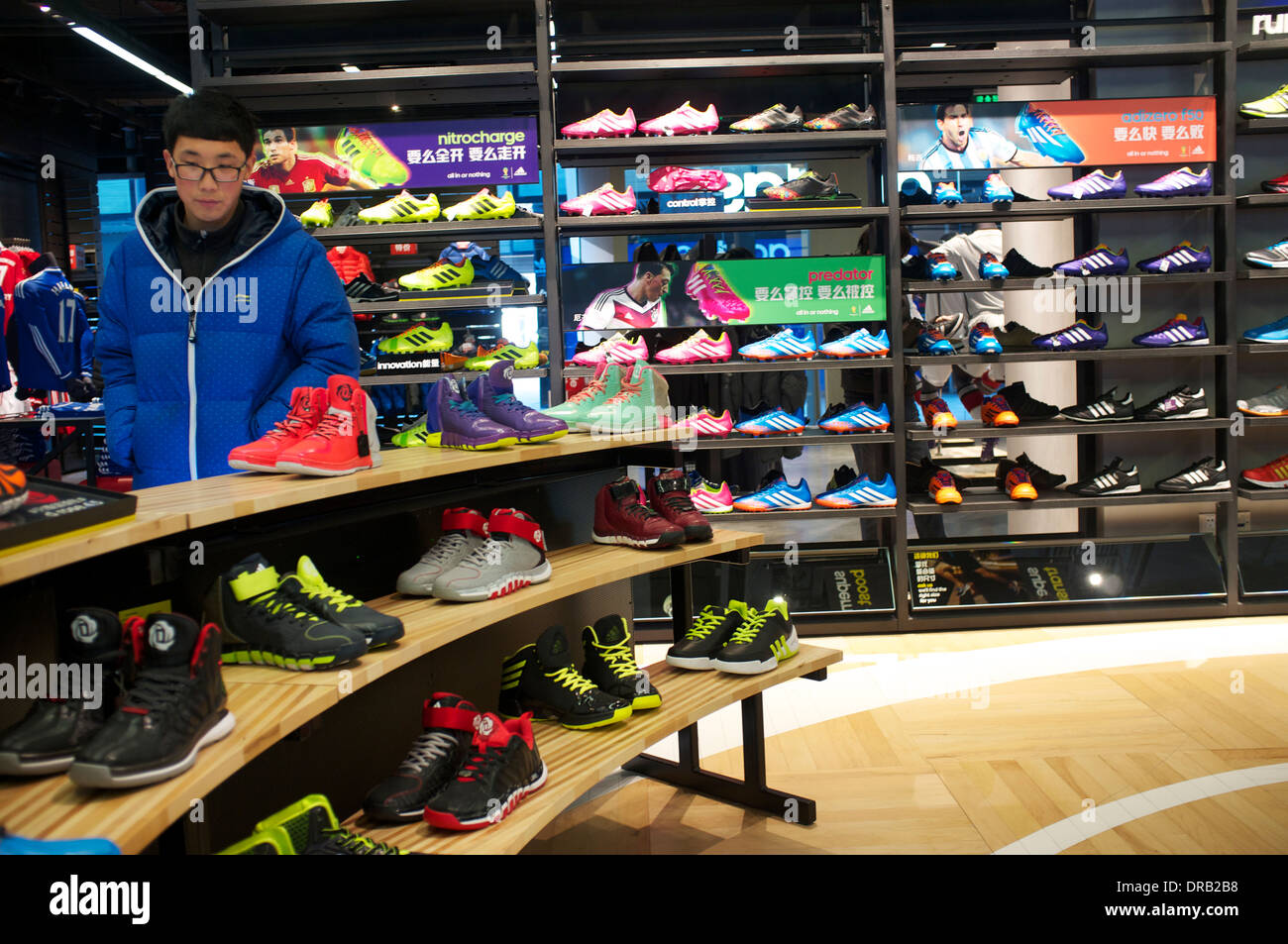 People shop at Adidas outlet in Beijing, China. 21-Jan-2014 Stock Photo -  Alamy